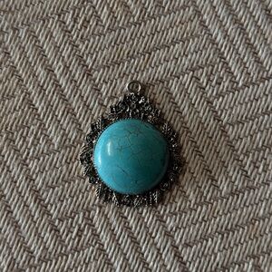 Electric blue Turquoise pendant veined with aqua, inlayed in a Rose Bush backing